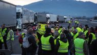 Yellow vest (Gilet jaune) protestors gather and block the A9 highway toll of Le Boulou, southern France on December 21, 2018, during a demonstration against rising oil prices and living costs. / AFP / Raymond ROIG 