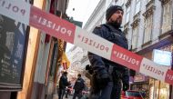Austrian policemen stand guard at the site of a shooting outside Figlmueller passage in the city center of Vienna, Austria, on December 21, 2018. AFP / JOE KLAMAR
