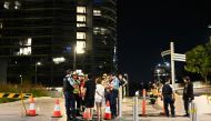 Police check the unit numbers of the residents after an inspection of the Opal Tower by firefighters and engineers in Sydney on December 25, 2018.  / AFP / SAEED KHAN 