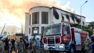  A picture taken on December 25, 2018 shows a firetruck and security officers at the scene of an attack outside the Libyan foreign ministry headquarters in the capital Tripoli. AFP / Mahmud TURKIA