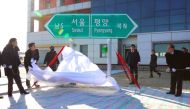 South and North Korean officials unveil a direction signboard for Seoul and Pyongyang during a groundbreaking ceremony for reconnecting and repairing roads and railways across the divided Korean peninsula at Panmun Station in North Korea's border city of 