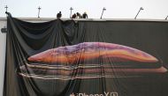 Workers adjust a hoarding of the newly launched iPhone XS in Ahmedabad, India October 4, 2018. (Reuters /Amit Dave/File Photo)