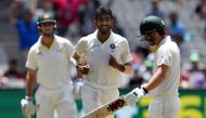 Australia's batsman Travis Head (R) walks off the field as India's paceman Jasprit Bumrah (C) celebrates his dismissal during day three of the third cricket Test match between Australia and India in Melbourne on December 28, 2018. AFP / WILLIAM WEST / -- 