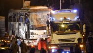 This picture taken on December 28, 2018 shows a tourist bus which was attacked being towed away from the scene, in Giza province south of the Egyptian capital Cairo. AFP / MOHAMED EL-SHAHED