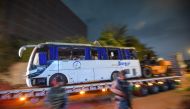 This picture taken on December 28, 2018 shows a tourist bus which was attacked being towed away from the scene, in Giza province south of the Egyptian capital Cairo. AFP / Mohamed el-Shahed