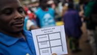 A man shows a ballot paper in an improvised polling station in the streets of a district in Beni, on December 30, 2018. AFP / ALEXIS HUGUET