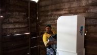 A woman in a polling booth asks for help while casting her ballot at the Matcha polling station in Sake, North Kivu, on December 30, 2018.  AFP / PATRICK MEINHARDT