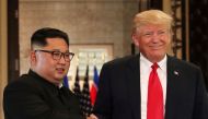 FILE PHOTO: U.S. President Donald Trump and North Korea's leader Kim Jong Un shake hands after signing documents during a summit at the Capella Hotel on the resort island of Sentosa, Singapore June 12, 2018. REUTERS/Jonathan Ernst