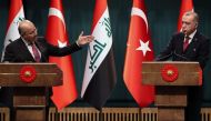 Iraqi President Barham Salih (L), flanked by Turkish President Recep Tayyip Erdogan (R), gestures as he speaks during a joint press conference at the Presidential Complex in Ankara, on January 3, 2019. / AFP / ADEM ALTAN
