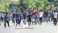 Indian protesters throw stones at police during a demonstration over two women entering the Sabarimala Ayyapa temple, in Palakkad in southern Kerala state on January 3, 2019. (AFP)
