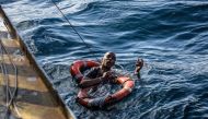 A migrant is being rescued on January 4, 2019 with buoys and a rope, after he dived in the cold Mediterranean off Malta's coast from the Dutch-flagged Sea-Watch 3 rescue vessel, in a attempt to reach the shore by swimming. The Sea-Watch 3, a Dutch-flagged