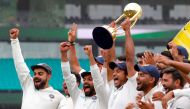 India's captain Virat Kohli (L) celebrates with teammates as they pose with the Border-Gavaskar Trophy after winning the Test series between India and Australia at the Sydney Cricket Ground on January 7, 2019.AFP / DAVID GRAY 