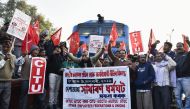 Indian activists from the Centre of Indian Trade Unions (CITU), which is politically aligned with the Communist Party of India (Marxist), block trains at Guwahati Railway Station during a nationwide strike in Guwahati in India's eastern Assam state on Jan