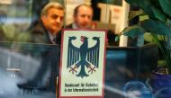 FILE PHOTO: Security personnel sits behind the bullet-proof window at the headquarters of Germany's BSI national cyber defence body in Bonn, Germany, January 4, 2019, after personal data and documents of German politicians and public figures have been pub