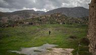 Ridvan Ayhan, a 58-year-old activist who fights against the Ilisi hydroelectric dam project, walks at a historical site in Hasankeyf, in Turkey's Kurdish-majority southeast, on December 13, 2018. AFP / BULENT KILIC
