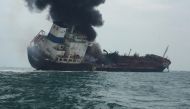 Smoke rising from an oil tanker as it tilts to one side in the waters near Hong Kong.  AFP / Hong Kong Police