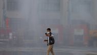 Bangkok authorities wash the dust off streets in the capital city after the particulate matter (PM2.5) reached hazardous levels in Bangkok, Thailand January 14, 2019. Reuters/Soe Zeya Tun