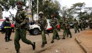 Kenyan policemen walk from the scene where explosions and gunshots were heard at the Dusit hotel compound in Nairobi, Kenya, January 16, 2019. REUTERS/Thomas Mukoya