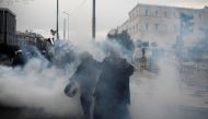 A priest reacts next to police officers during a demonstration against the agreement reached by Greece and Macedonia to resolve a dispute over the former Yugoslav republic's name, in Athens, Greece, January 20, 2019. Reuters/Alkis Konstantinidis 