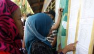 Residents look for their names at the list at Simuay Junction Central Elementary School, to cast their votes during the referendum in Sultan Kudarat town of Maguindanao province in Philippines on January 21, 2019.(Jeoffrey Maitem/Anadolu Agency)