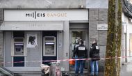 French police check the entrance to the Milleis Banque close to the Champs-Elysees Avenue in central Paris on January 22, 2019, following a robbery earlier in the day. Criminals entered the bank holding people on the premises hostage for several hours as 