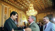 In this file photo of Venezuelan President Nicolás Maduro (left) and Igor Sechin, president of the Russian state-owned oil company Rosneft, exchanging greetings during a meeting in Caracas. Sechin is a frequent visitor to Venezuela for massive business in