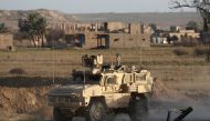 A US military vehicle drives through the Syrian village of Baghuz in the countryside of the eastern Deir Ezzor province on January 26, 2019.  AFP / DELIL SOULEIMAN
