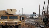 A picture taken on January 27, 2019 in the Syrian village of al-Susah in the countryside of Syria's eastern Deir Ezzor province, near the border with Iraq, shows fighters from the Kurdish-led Syrian Democratic Forces (SDF) heading to the frontline with th