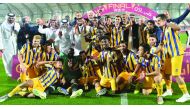 Al Gharafa’s players and officials celebrate with the QSL Cup after winning the final against Al Duhail yesterday. 