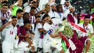Qatar’s captain Hassan Al Haydos (centre) raises the trophy as he celebrates their win during the AFC Asian Cup final against Japan held at the Mohammed Bin Zayed Stadium in Abu Dhabi on February 1.