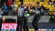 New Zealand's Ish Sodhi (R) with teammates Tim Seifert (C) and Daryl Mitchell (L) celebrate their win in the first Twenty20 cricket match between New Zealand and India in Wellington on February 6, 2019. / AFP / Marty MELVILLE