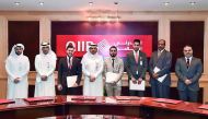 Dr Abdulbasit Ahmad Al Shaibei (fourth left), CEO, QIIB; and Jamal Abdullah Al Jamal (second left), Deputy CEO, QIIB, with other officials and top performing employees of QIIB, during the honouring ceremony.
