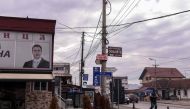A man walks next to the portrait of the Serbian President displayed at the office of a Serbian political party in the town of Gracanica near Pristina on December 29, 2018. AFP/Armend Nimani