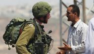 A Palestinian argues with an Israeli soldier during clashes near the West Bank village of Qusra, west of Nablus, August 9, 2016. Reuters/Mohamad Torokman