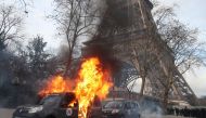 A Sentinelle security operation car burns in front of the Eiffel Tower, on the sidelines of a demonstration in Paris on February 9, 2019, as the 