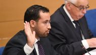 In this file photo taken on September 19, 2018, Former Elysee senior security officer Alexandre Benalla raises his hand as he takes the oath before a Senate committee in Paris. AFP/Alain Jocard
