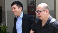 Singaporean activist Jolovan Wham (L) arrives at the State Court in Singapore on February 21, 2019 to face sentence for organising alleged illegal protest. / AFP / Roslan RAHMAN