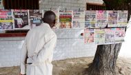 A man looks at newspaper front pages hung on a rope in Fann Hock neighbourhood, in Dakar, on February 25, 2019, one day after Senegal's presidential elections. AFP / SEYLLOU