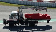 The car of Ferrari's Sebastian Vettel is taken off the track after a crash during testing REUTERS/Albert Gea