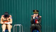 Two Vietnamese policewomen rest near the Melia hotel following the second US-North Korea summit in Hanoi on February 28, 2019. AFP / Ye Aung Thu
 