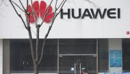 A woman walks past a Huawei store in Beijing, China March 2, 2019. Picture taken March 2, 2019. REUTERS/Jason Lee
