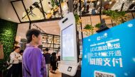 A customer tries Alipay's facial recognition payment solution 
