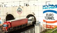 In this file photo taken on October 20, 2015 trucks arrive through a new Eurotunnel freight tunnel, created to increase cross-English Channel trading in Coquelles. AFP / Philippe Huguen  