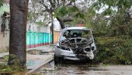 A destroyed car is seen amid the destruction provoked by the passage of the cyclone Idai in Beira, Mozambique, on March 17, 2019. AFP / ADRIEN BARBIER
