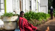 Edna kabayanjiri, 34, sits in the morning sun outside the Chimanimani Hotel where a hundred of affected residents, mostly women and children, are sheltered in Chimanimani on March 20, 2019. AFP / Zinyange Auntony
 