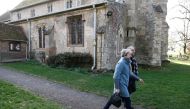 Britain's Prime Minister Theresa May (L) leaves with her husband Philip (R) after attending a church service, near her Maidenhead constituency, west of London on March 24, 2019.  AFP / Adrian DENNIS