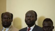 Thirty-five year-old Peter Biar Ajaj (C) looks on during his first appearance before the judiciary headquarters in Juba, South Sudan on March 21, 2019.  AFP/Akuot Chol 