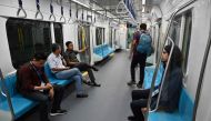 This picture taken on March 12, 2019 shows passengers on board a Jakarta mass rapid transit (MRT) coach during a trial run in the city.  AFP / Bay Ismoyo 
