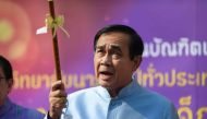 Thailand's Prime Minister Prayut Chan-O-Cha holds up a a traditional flute as he arrives at the Government House for a cabinet meeting in Bangkok on March 26, 2019, two days after the country's general election. / AFP / Ye Aung THU 