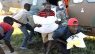 Workers offload food aid from a South African National Defence Force helicopter in the aftermath of Cyclone Idai in Buzi, near Beira, Mozambique, March 25, 2019. Reuters/Mike Hutchings